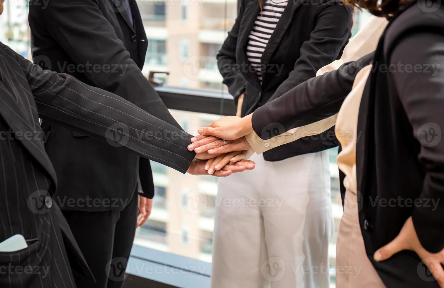 Successful and teamwork concept, Business people team joining hands after meeting in modern office photo