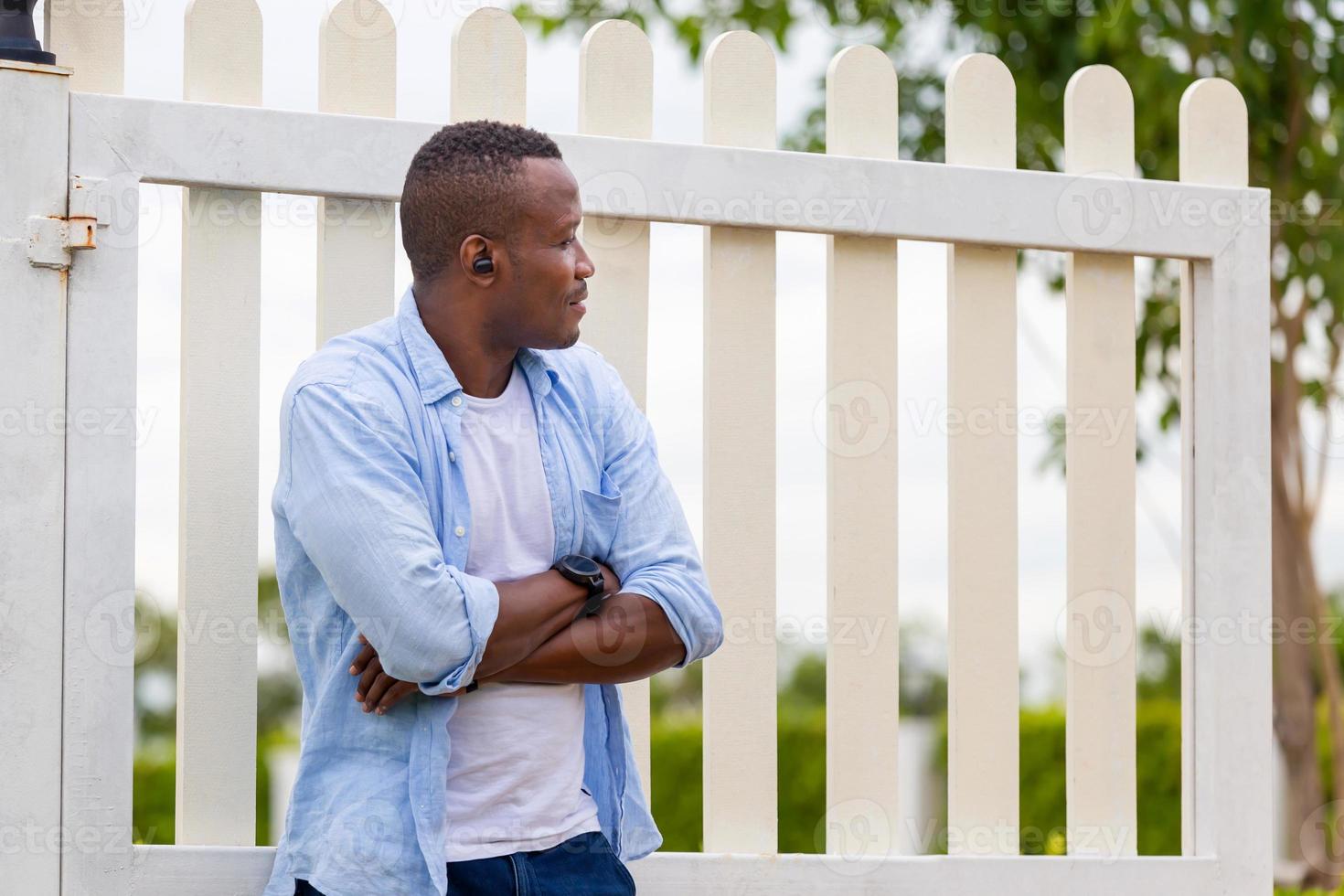 Portrait of man in back yard garden, Cheerful African American man standing with arms crossed photo