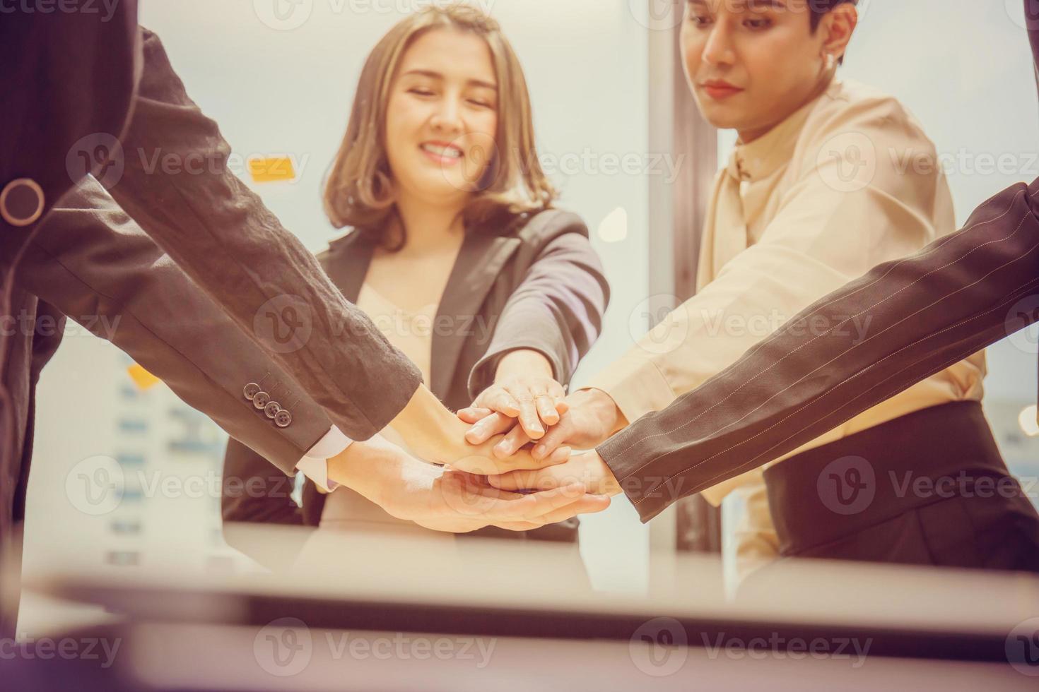 Successful and teamwork concept, Business people team joining hands after meeting in modern office photo