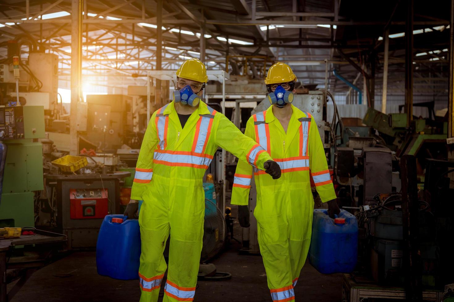 Industry engineering and teamwork wearing safety uniform control operating lathe grinding machine working in industry factory. photo