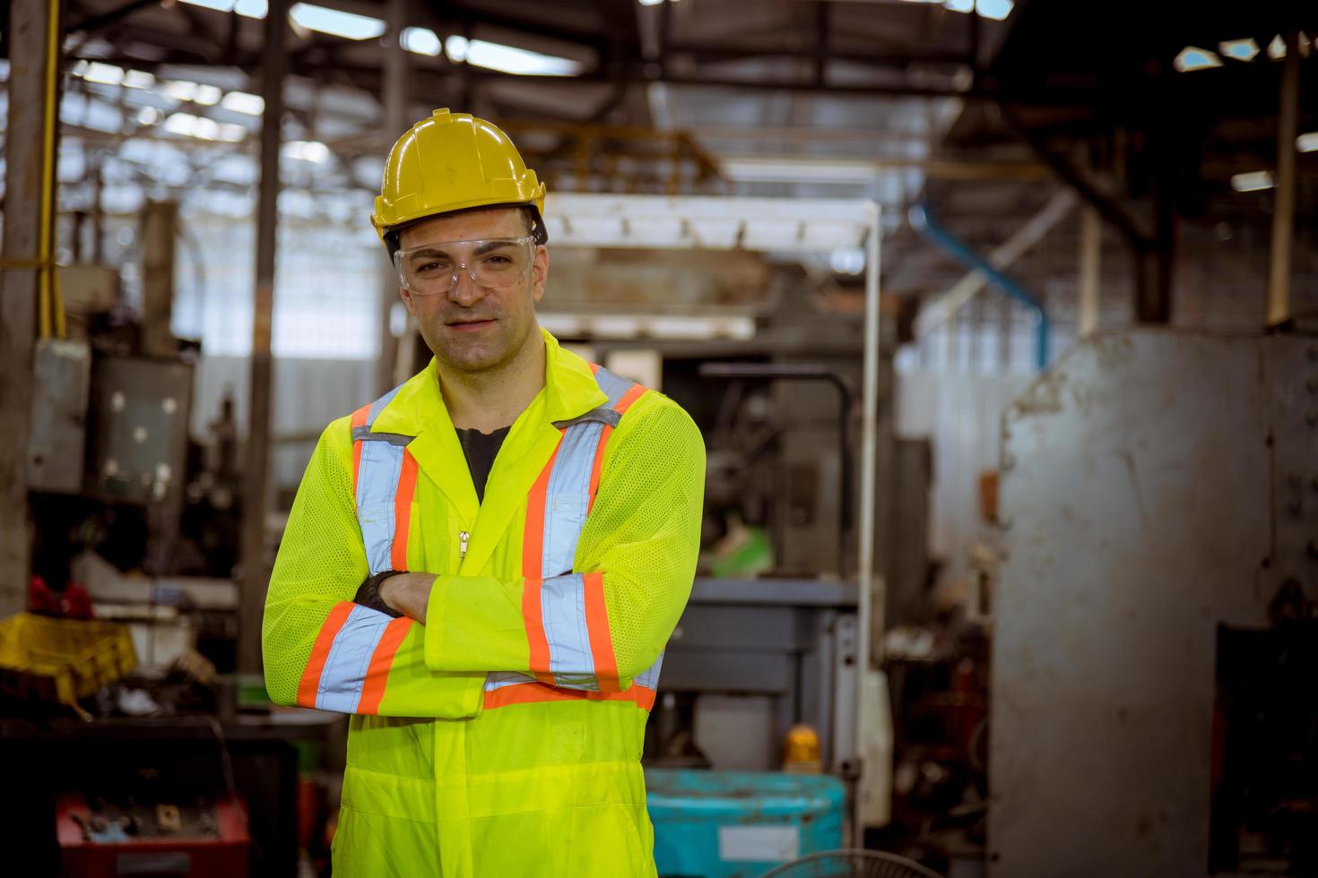 ingeniería industrial y trabajo en equipo con control uniforme de seguridad que opera la máquina rectificadora de torno que trabaja en la fábrica de la industria. foto