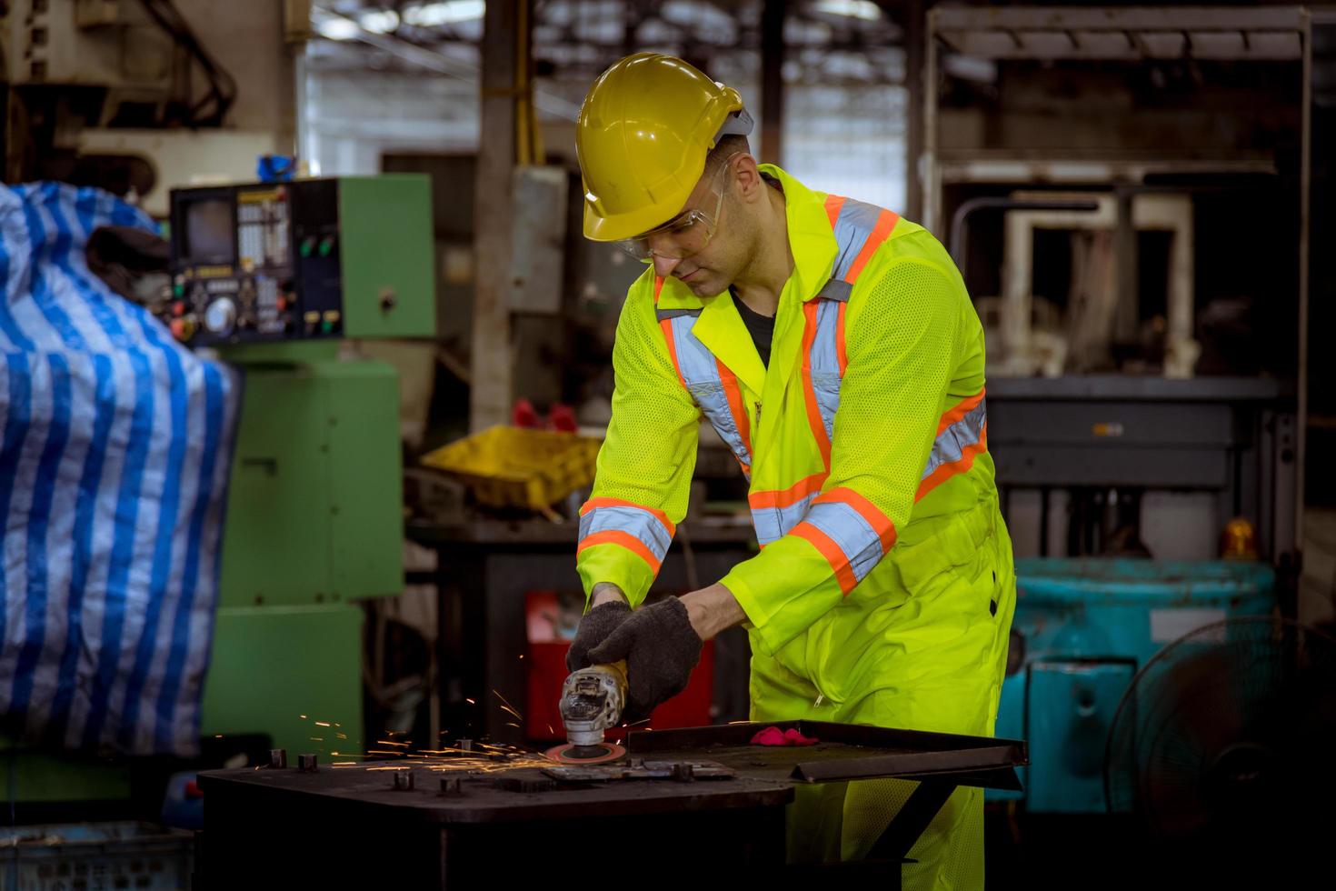 Industry engineering and teamwork wearing safety uniform control operating lathe grinding machine working in industry factory. photo