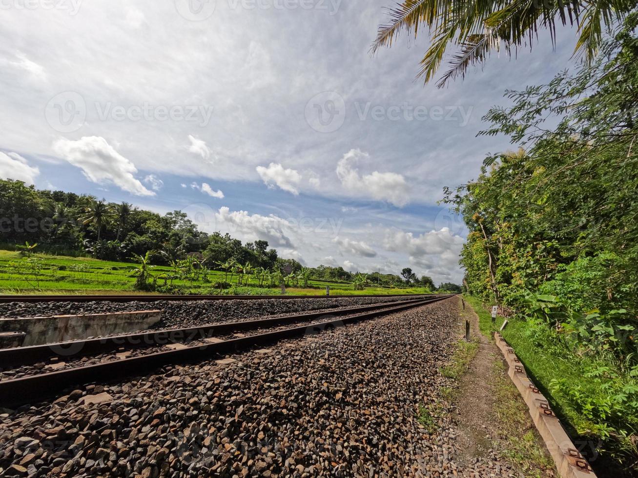 The view of the rail road in Yogyakarta Indonesia, visible rocks and a clear sky background photo