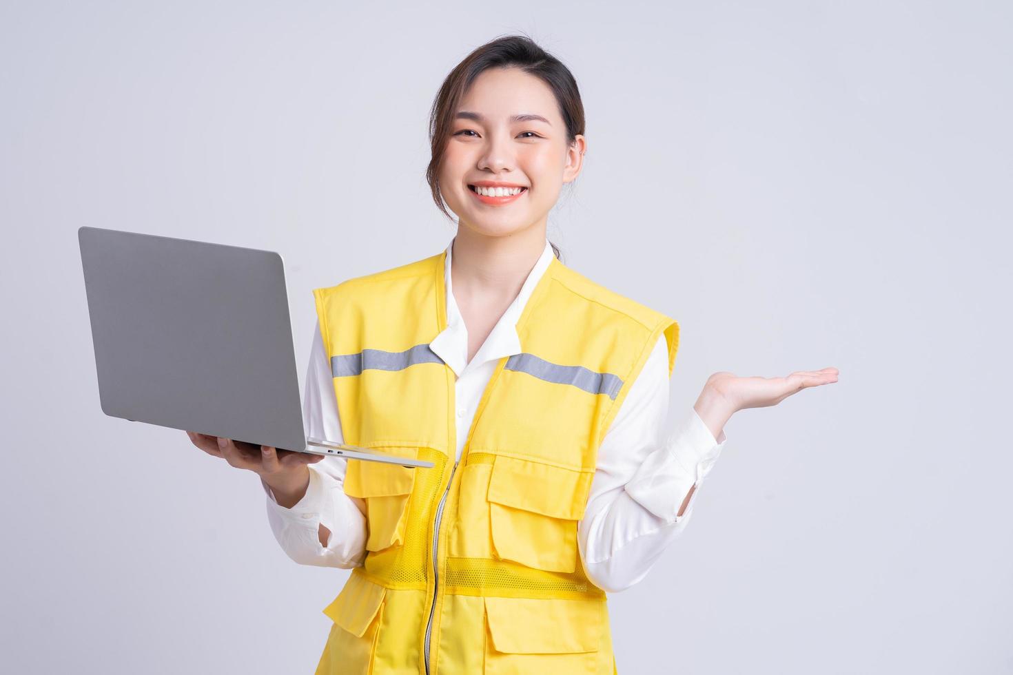 Portrait of Asian female construction engineer on white background photo