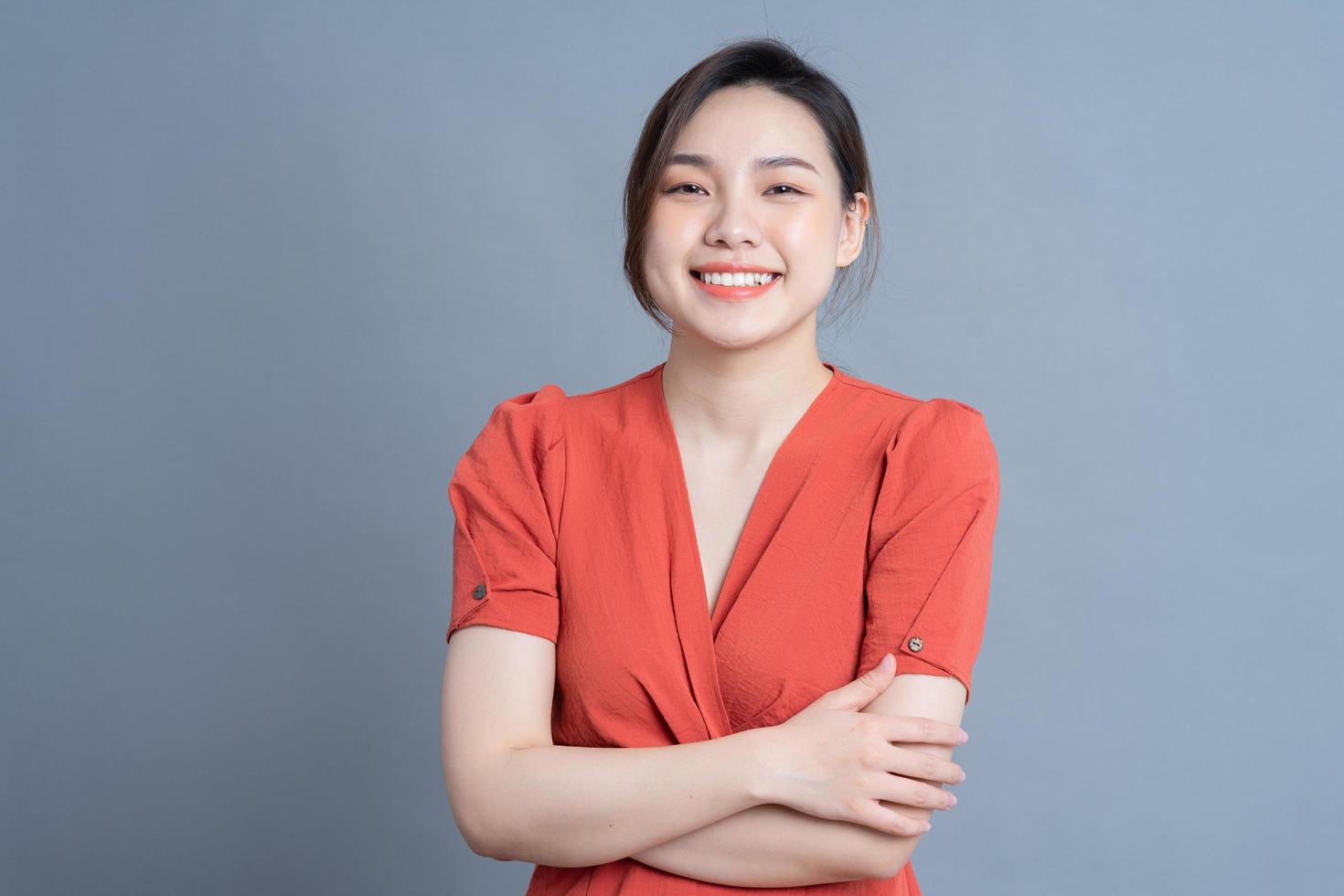 Young Asian woman posing on gray background photo
