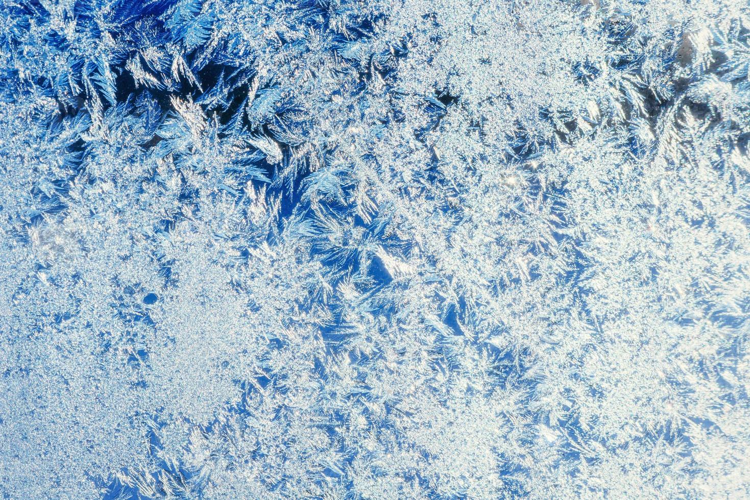 Frosty natural pattern on winter window photo