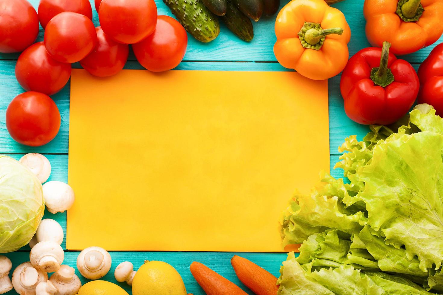 Different vegetables on kitchen table with recipe list and copy space. Top view photo