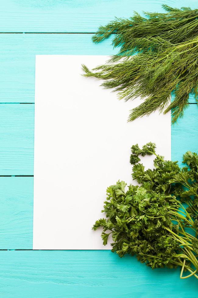 Different vegetables on kitchen table with recipe list and copy space. Top view photo
