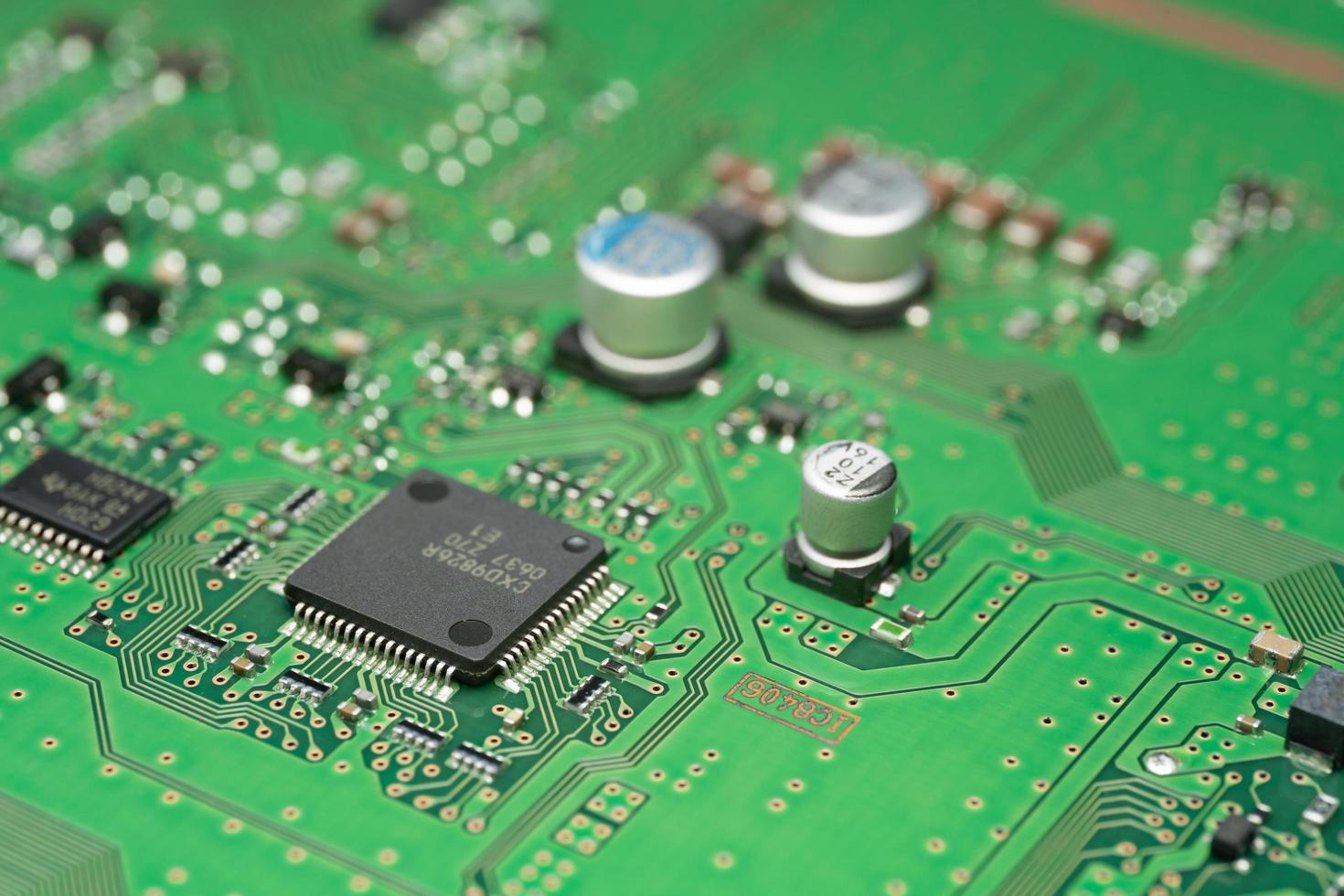 chip on green pcb board. Electronic circuit board close up. photo