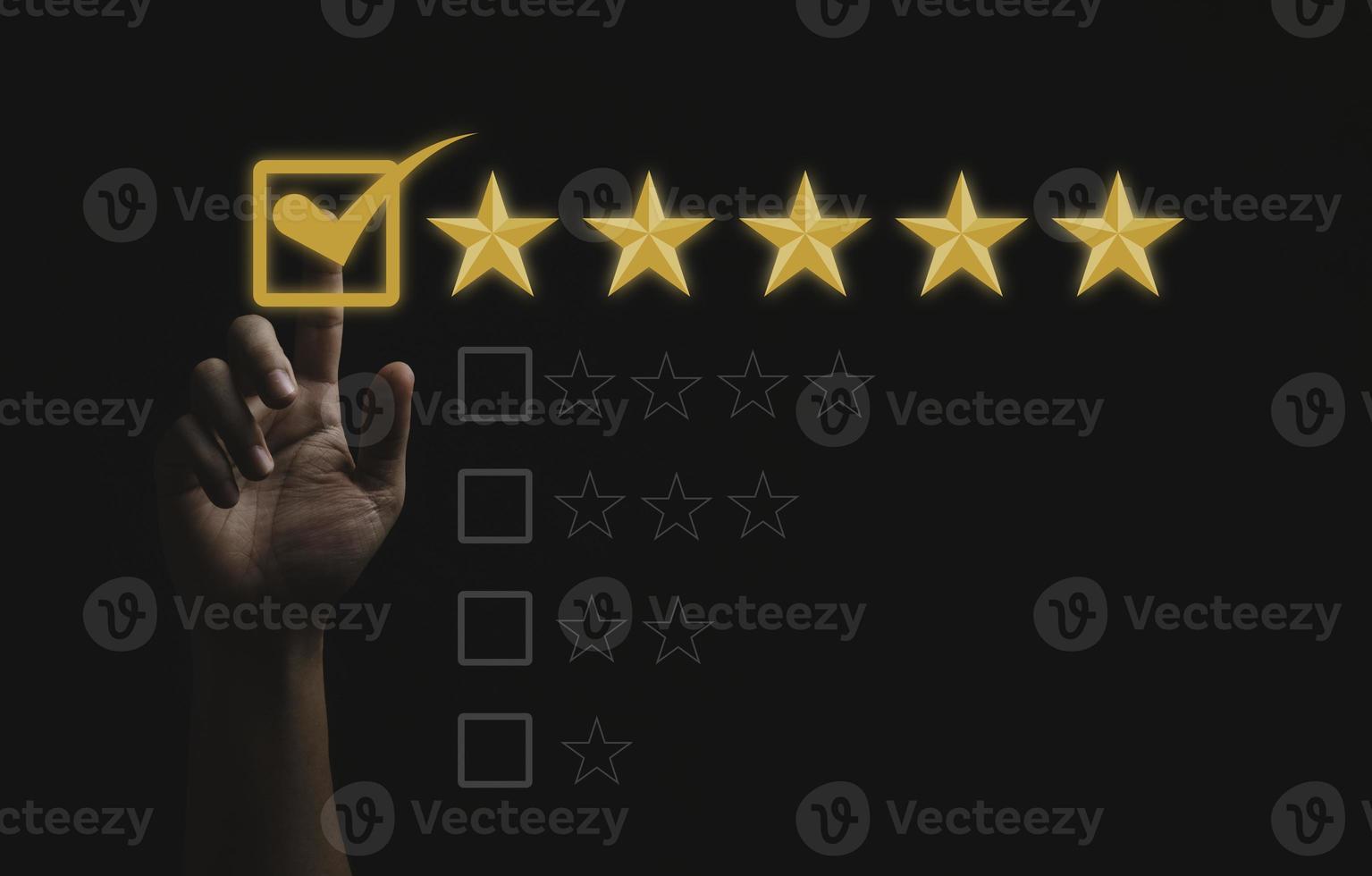 Hand touching and doing mark to five yellow stars on black background, the best customer satisfaction and evaluation for good quality product and service. photo