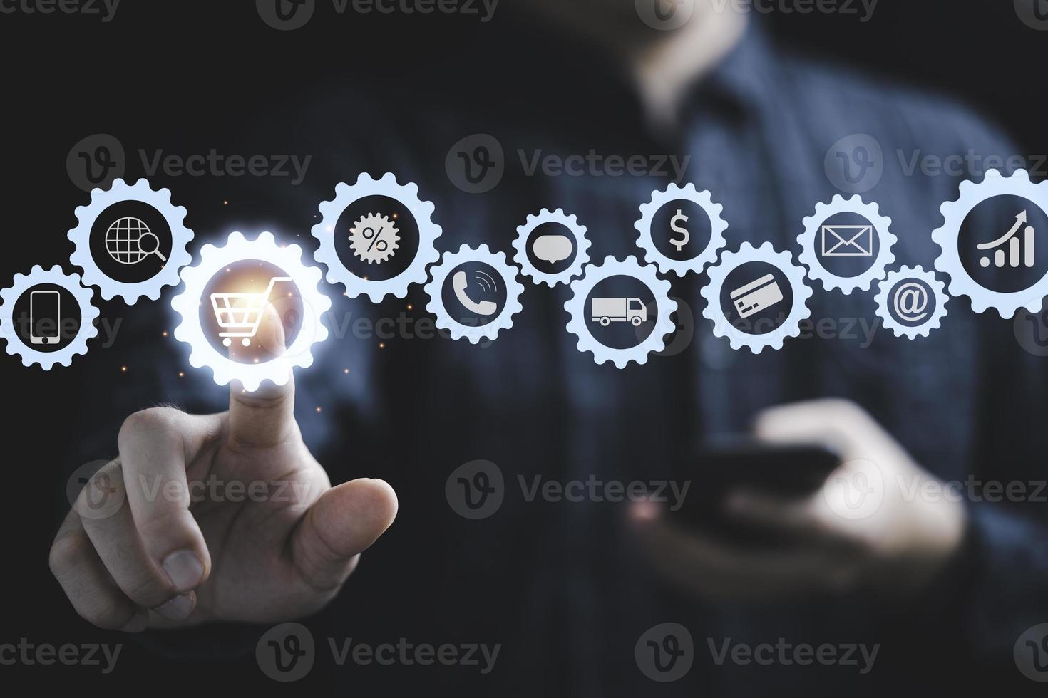 Businessman touching to virtual info graphics with trolley cart icons , Technology online shopping business concept. photo