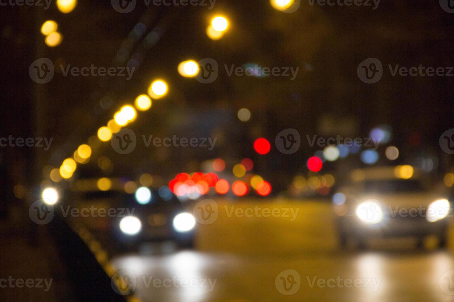 Out of focus light traffic on a street at night photo