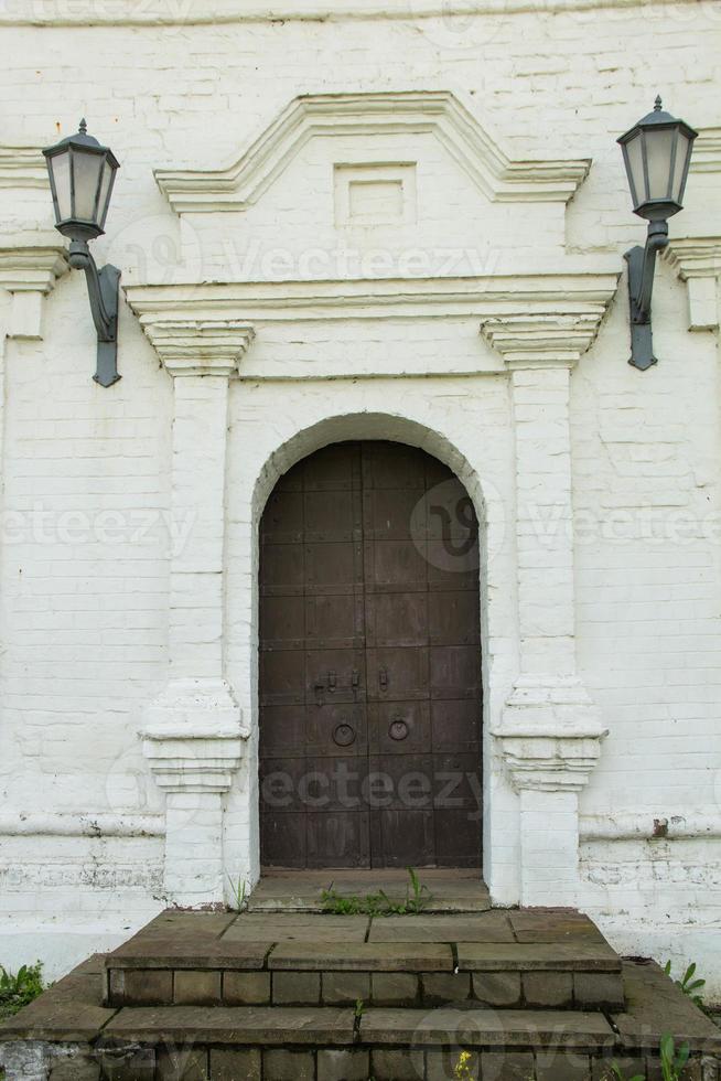 Old wooden door stone wall photo