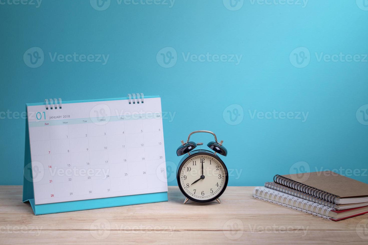 Vintage clock and calendar on wood, time concept photo