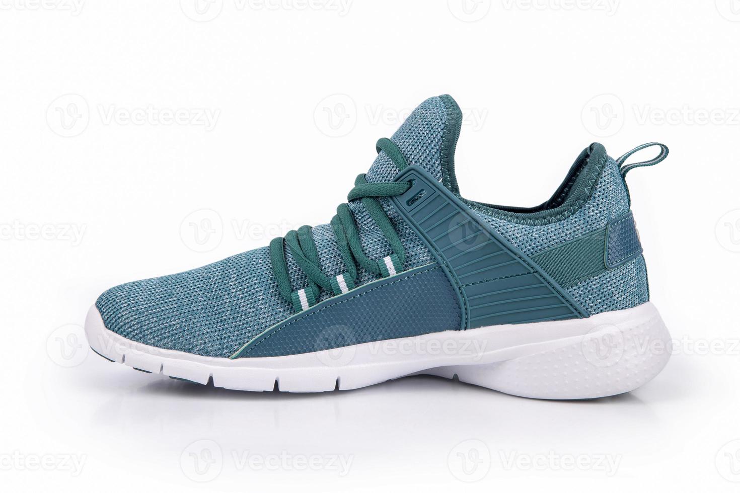 Green sneakers or sport running shoe isolated on a white background photo