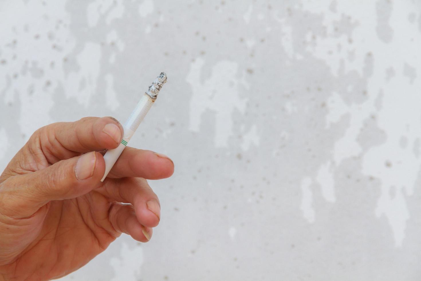 Hand hold cigarette have smoke, 31 may World no tobacco day. photo