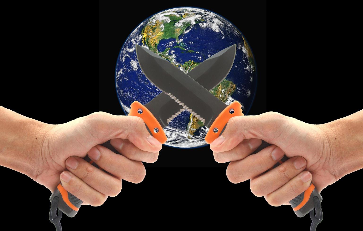 Concept, Hand holding a knife to stab the world. Violence in the world. Elements of this image furnished by NASA photo