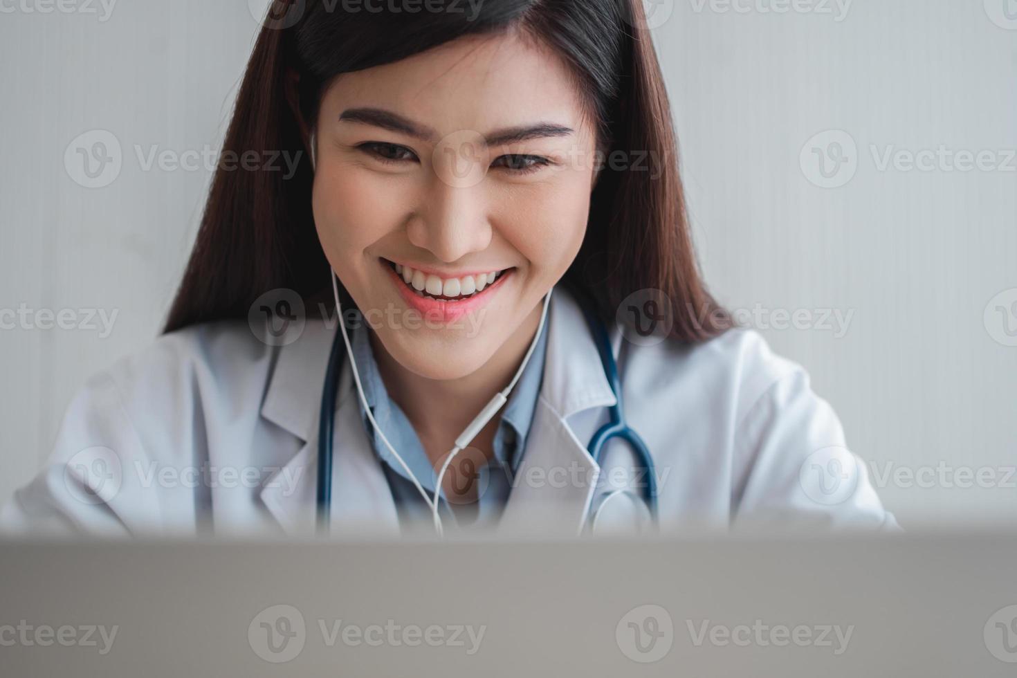 Asian therapist woman doctor is online visiting with a patient on the internet application. Her Listening and Give advice and explains how to treat the initial disease, Concept of Medical technology. photo