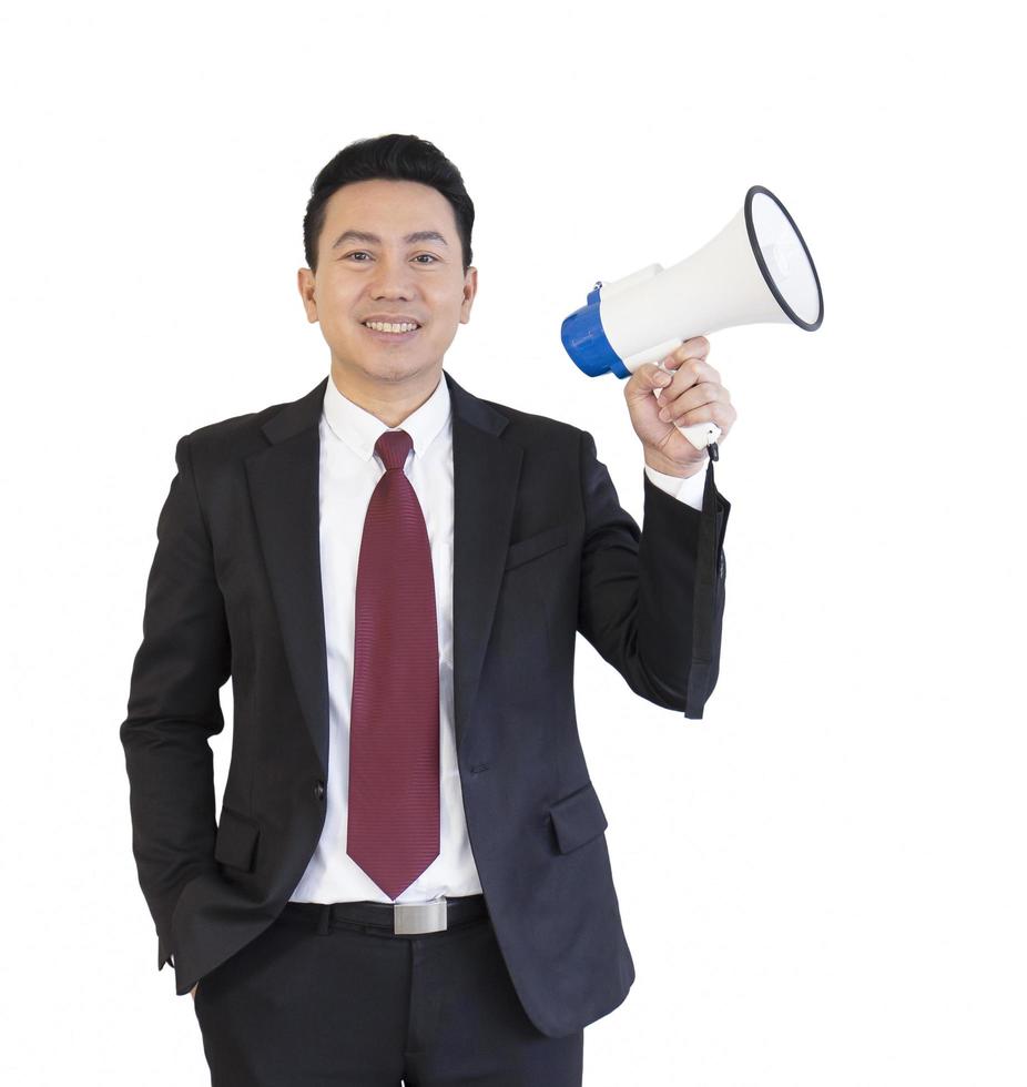 Asian man wearing a suit holding megaphone isolated on white background. photo