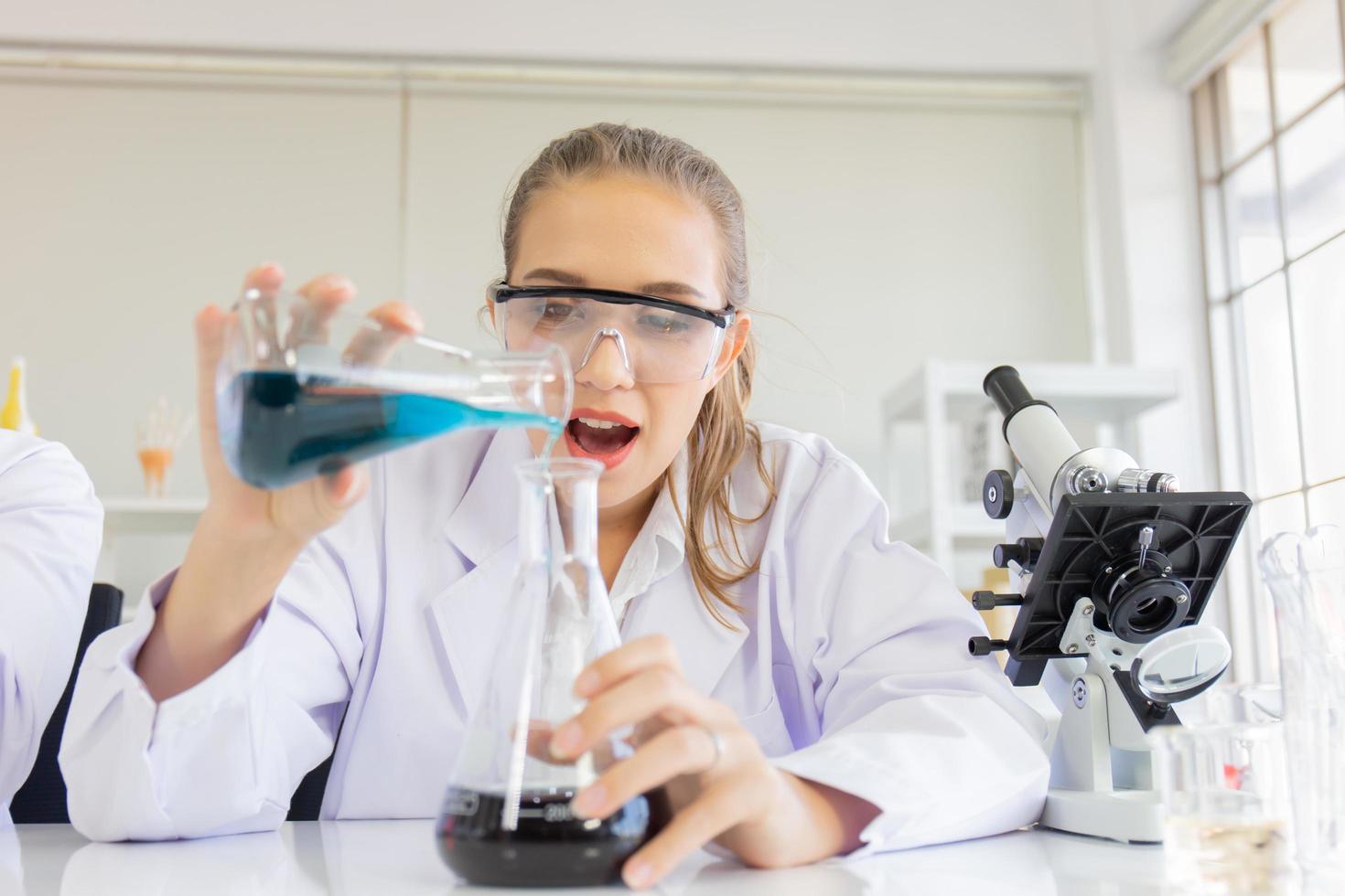 A beautiful female scientist is operating in a science lab with various equipment in the lab. photo