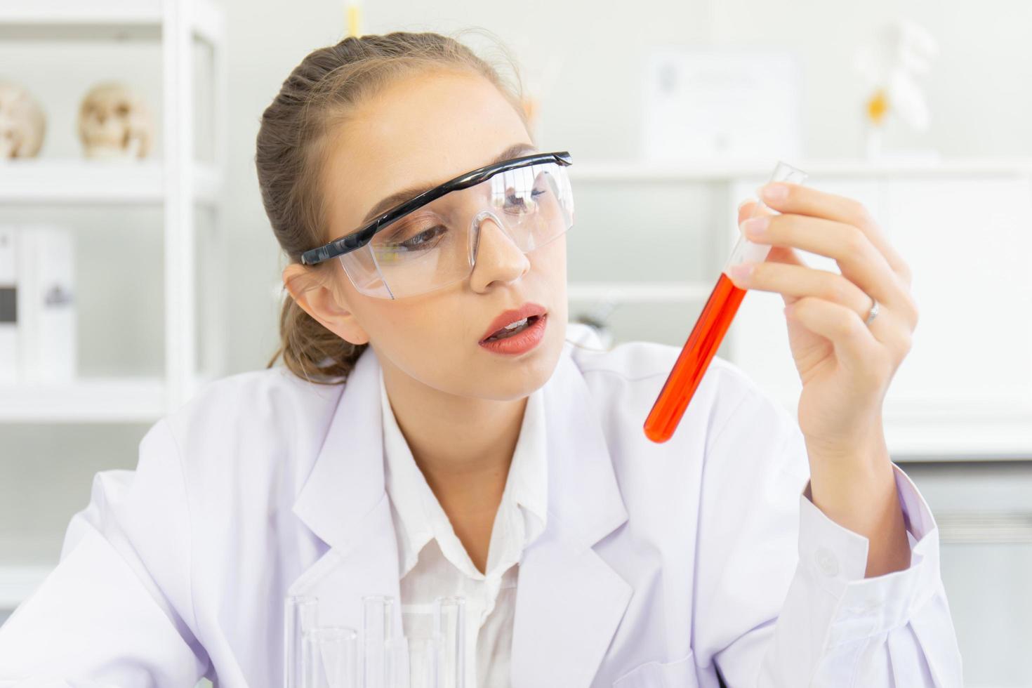 A beautiful female scientist is operating in a science lab with various equipment in the lab. photo