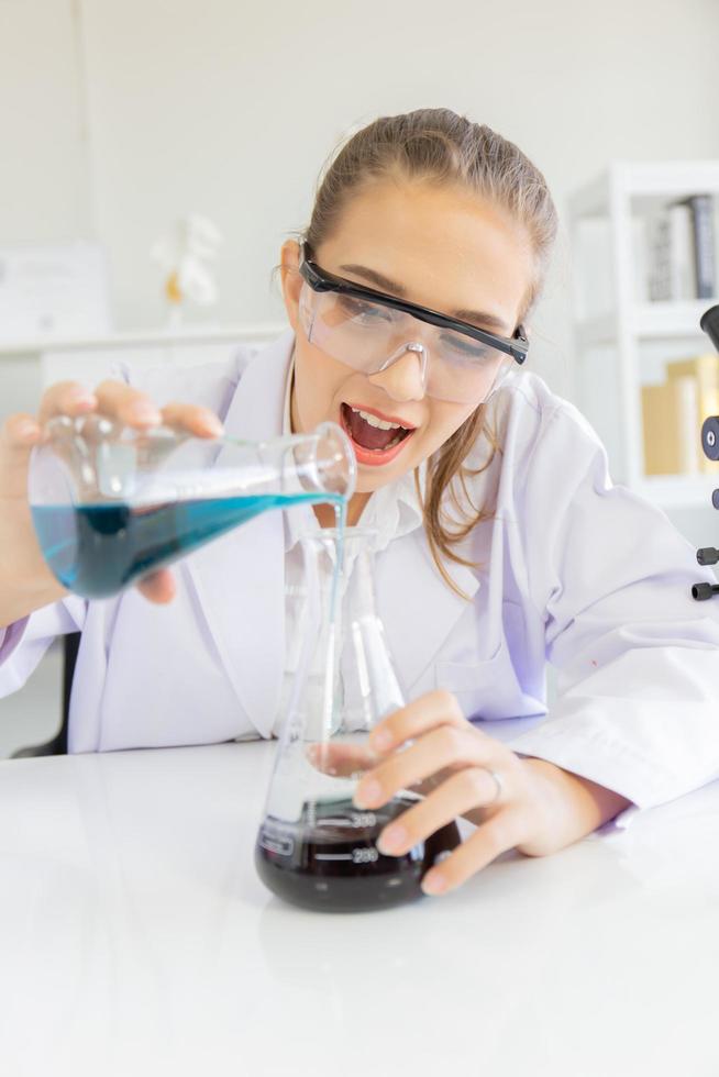 A beautiful female scientist is operating in a science lab with various equipment in the lab. photo