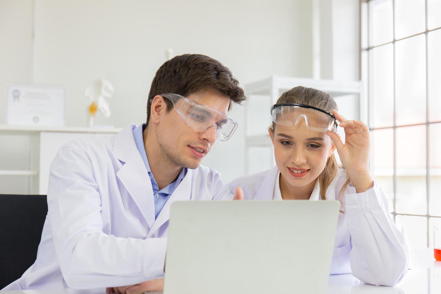 The concept of health care researchers, researchers working in biological science laboratories, young research scientists and male supervisors photo