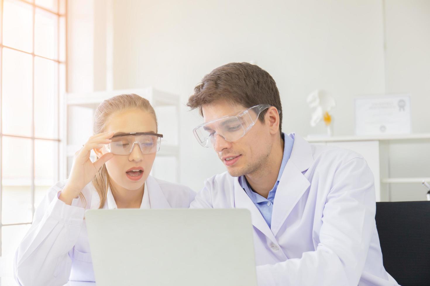The concept of health care researchers, researchers working in biological science laboratories, young research scientists and male supervisors photo
