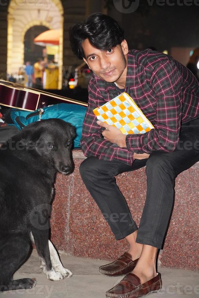 handsome man with black dog photo
