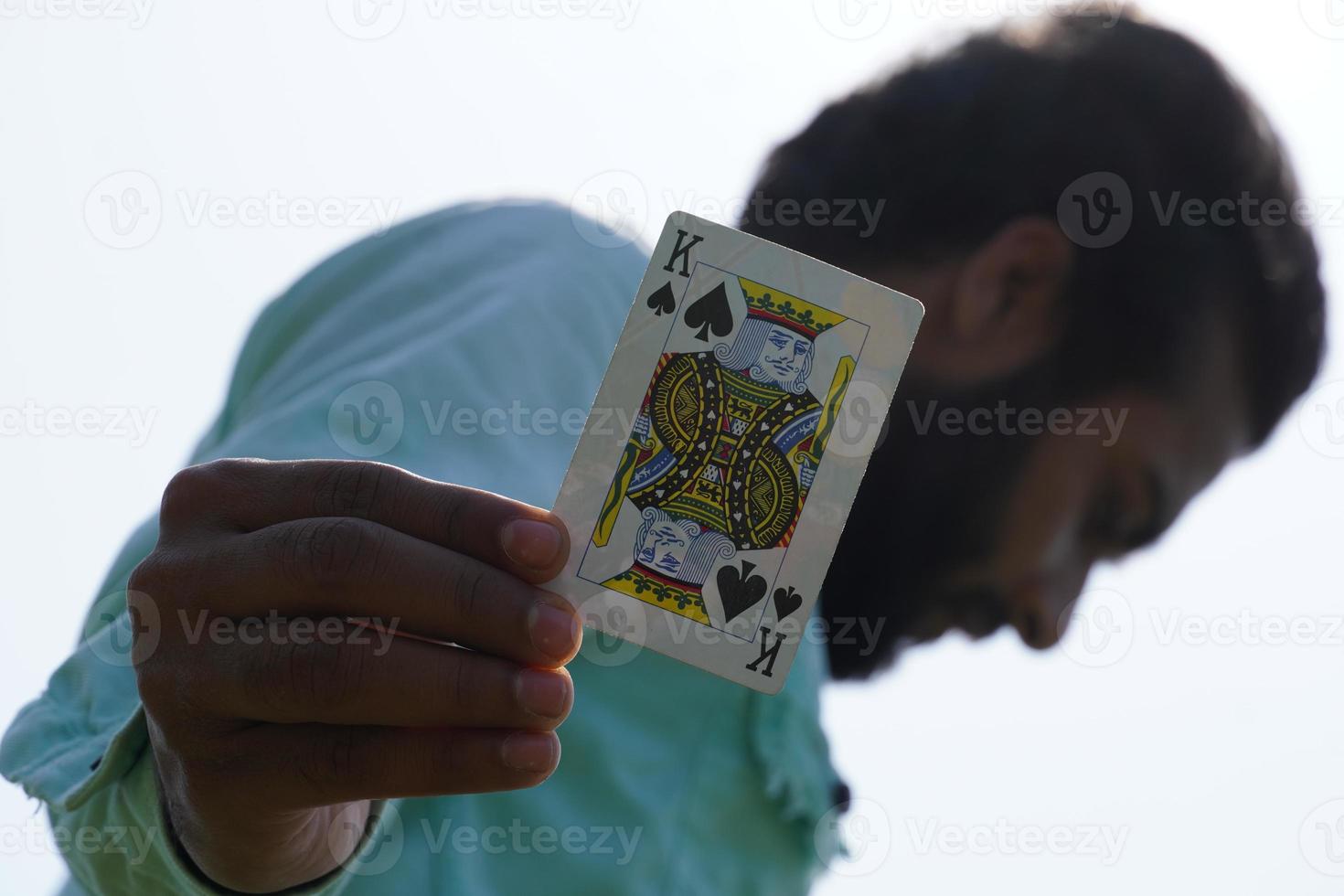 man with playing cards showing King Card - Poker concept photo