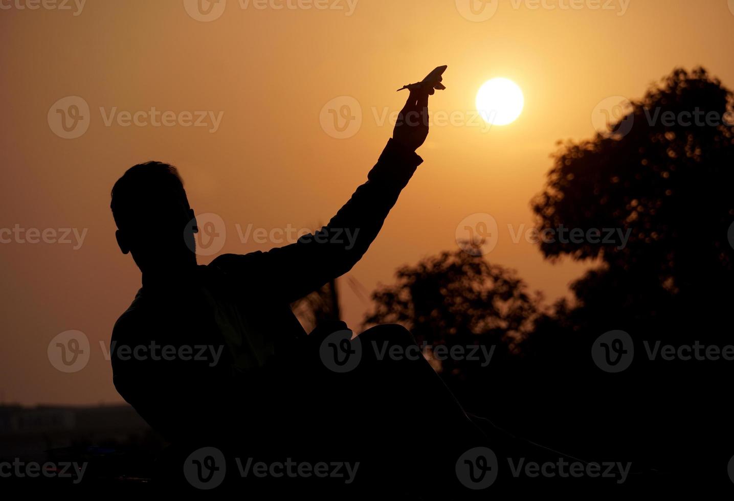 silhouette image of a boy with plane photo