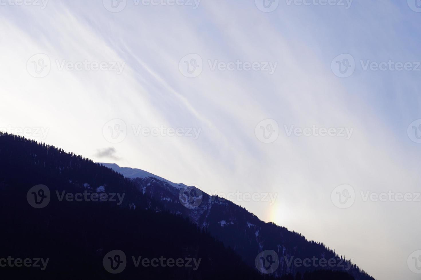 Close up view of a mountain with clouds photo