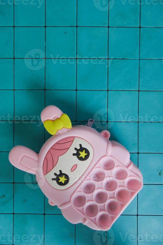 pop it childrens toys combined into a small bag. cute pink object. photo