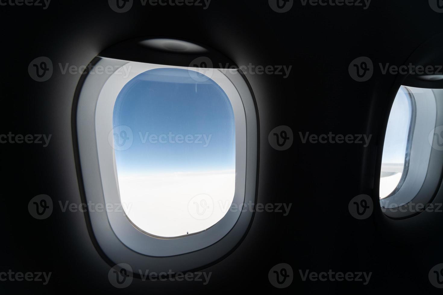 Airplane window view to cloudy sky and earth. Beautiful landscape from aircraft cabin. Flying without fear of flying, incidents and turbulence. photo