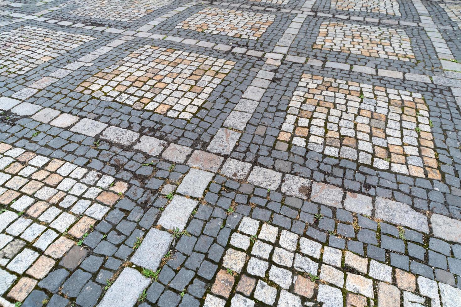 Tiles texture. Pattern of ancient german cobblestone in city downtown. Little granite paving stones. Antique gray pavements. photo