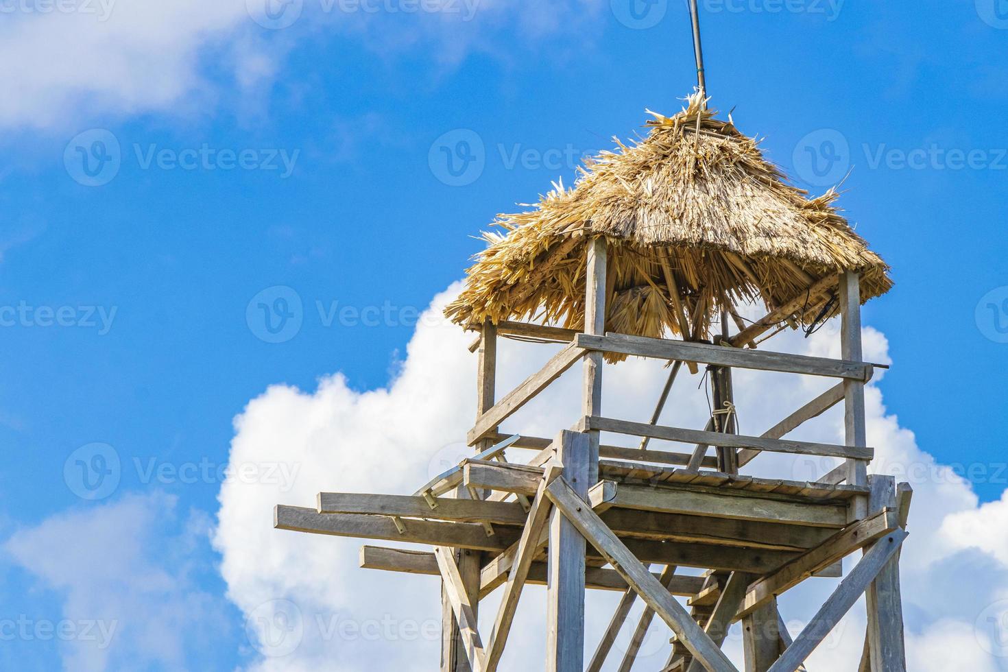 Wooden viewpoint tower with blue sky Muyil Lagoon panorama Mexico. photo