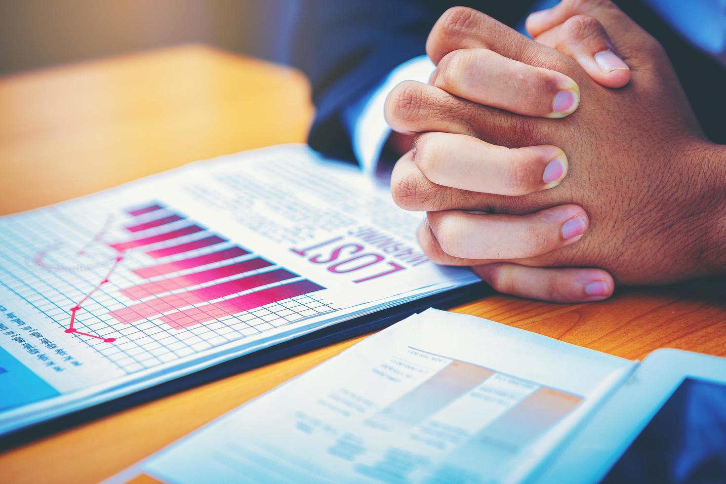 Bad investment or economic crisis concept. Crop image of businessman's hands holding from business disappointed and seriously by bad business results report. Selected focus. photo