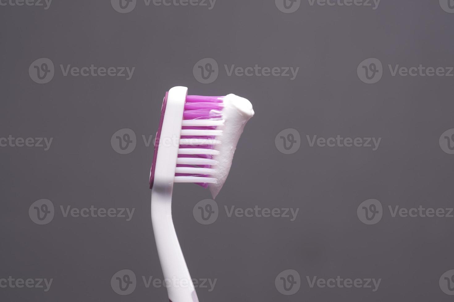 hand holding tooth brush with paste photo