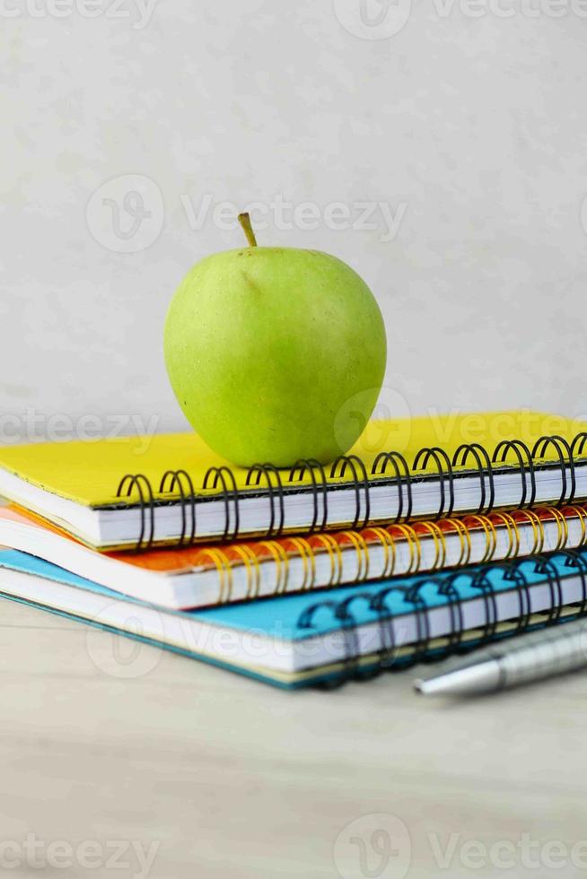 black to school concept with apple on notepad on table. photo