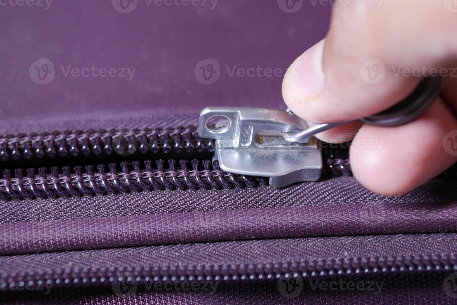 hand in a Zipper on a suitcase photo