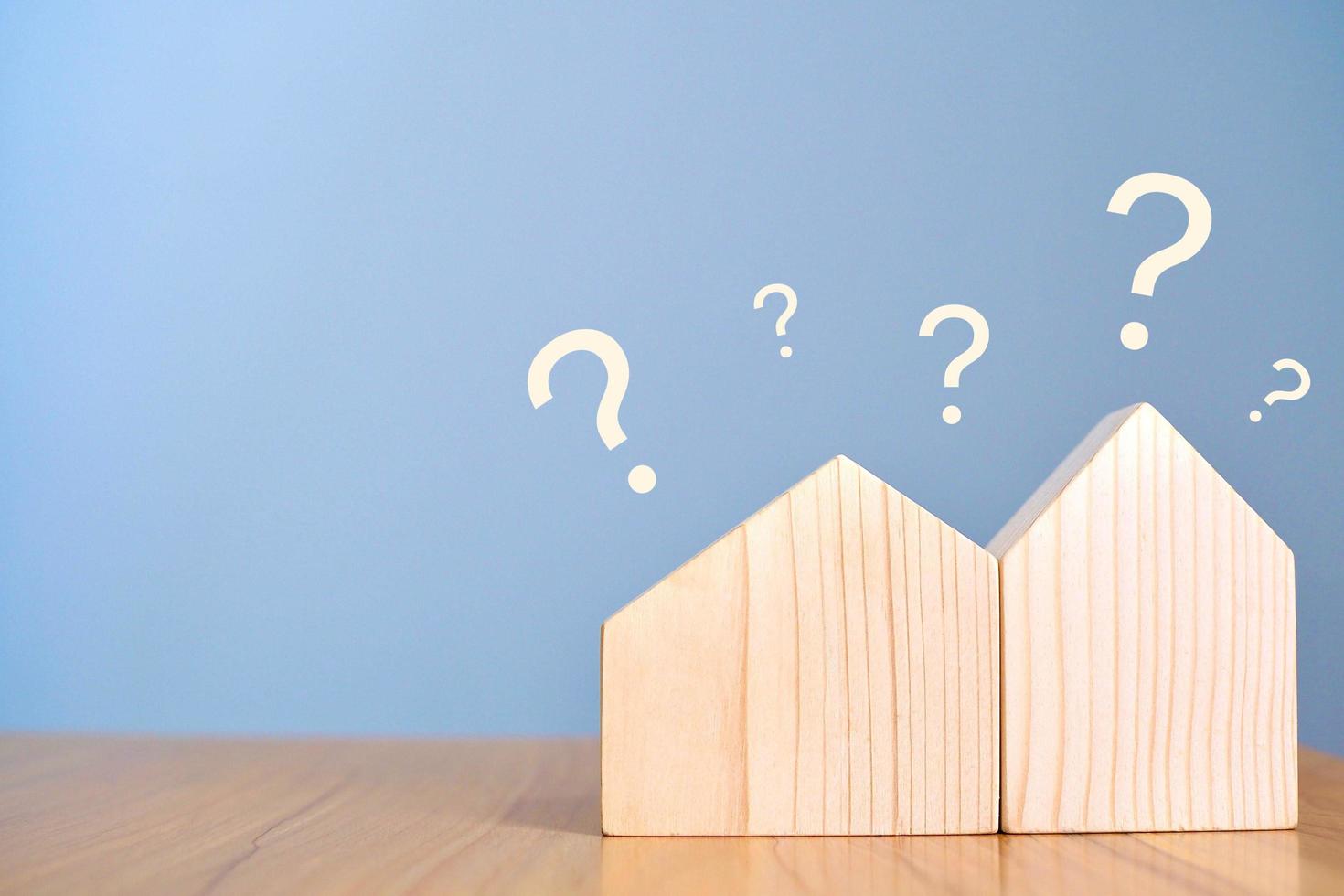 House object and wooden blocks with question mark on the table. photo