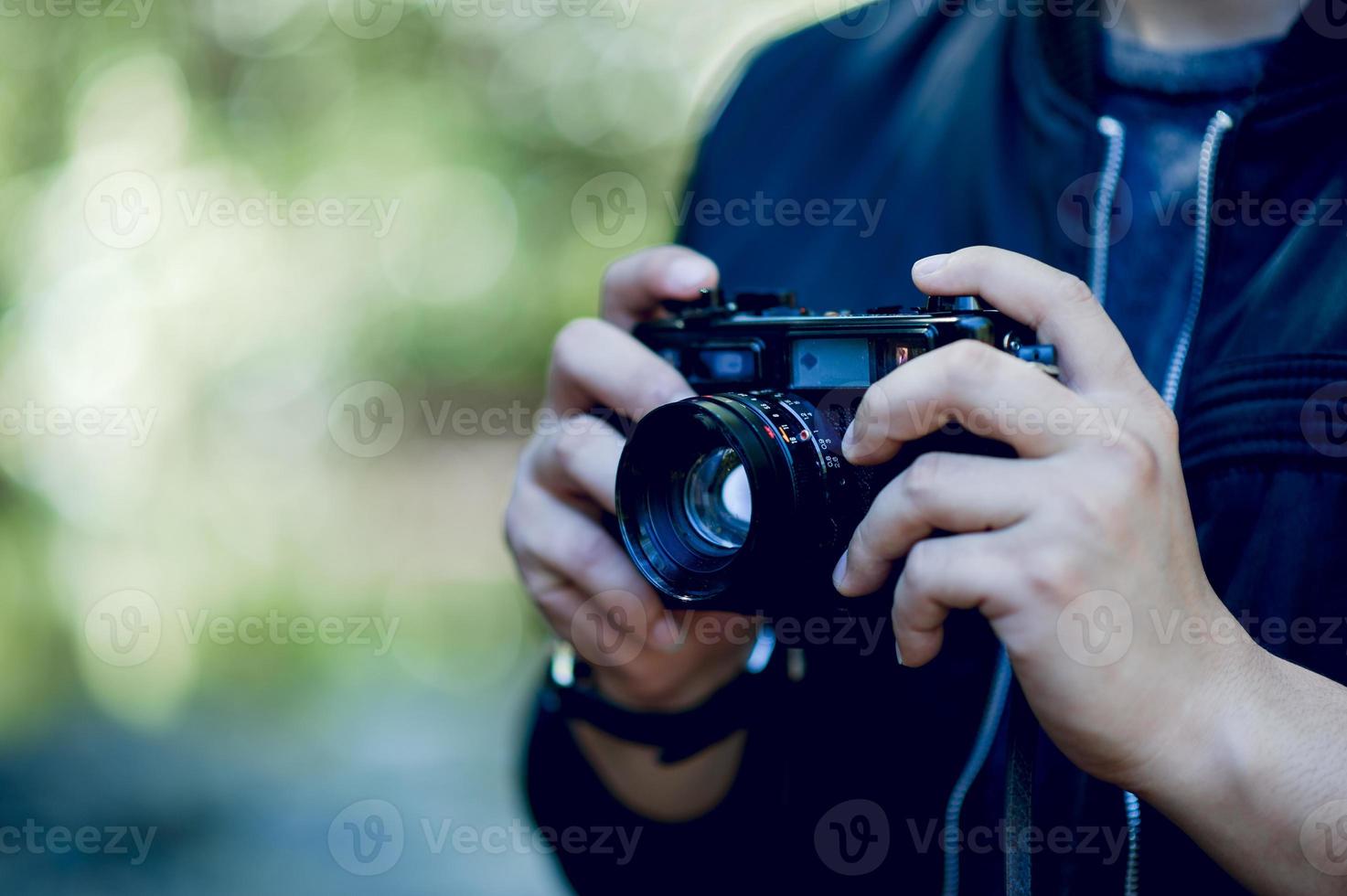 Hand and camera of the photographer Travel in the mountains and nature Concept photographer photo