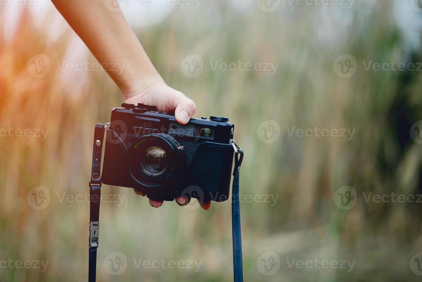 Hand and camera of the photographer Holding and carrying the camera to take pictures photo