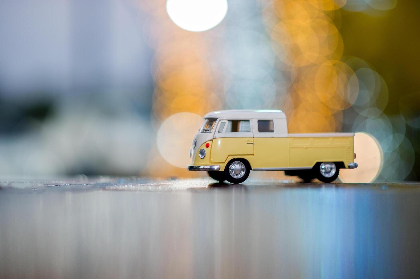 Classic yellow toy cars parked on wooden floors and have beautiful bokeh backgrounds. photo