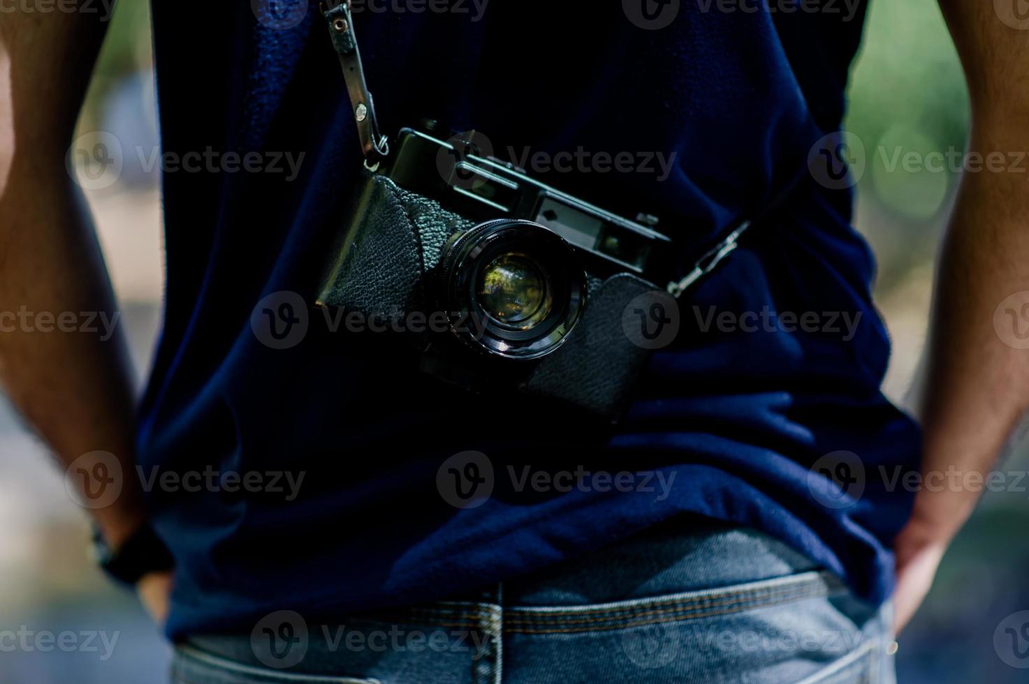 Hand and camera of the photographer Travel in the mountains and nature Concept photographer photo