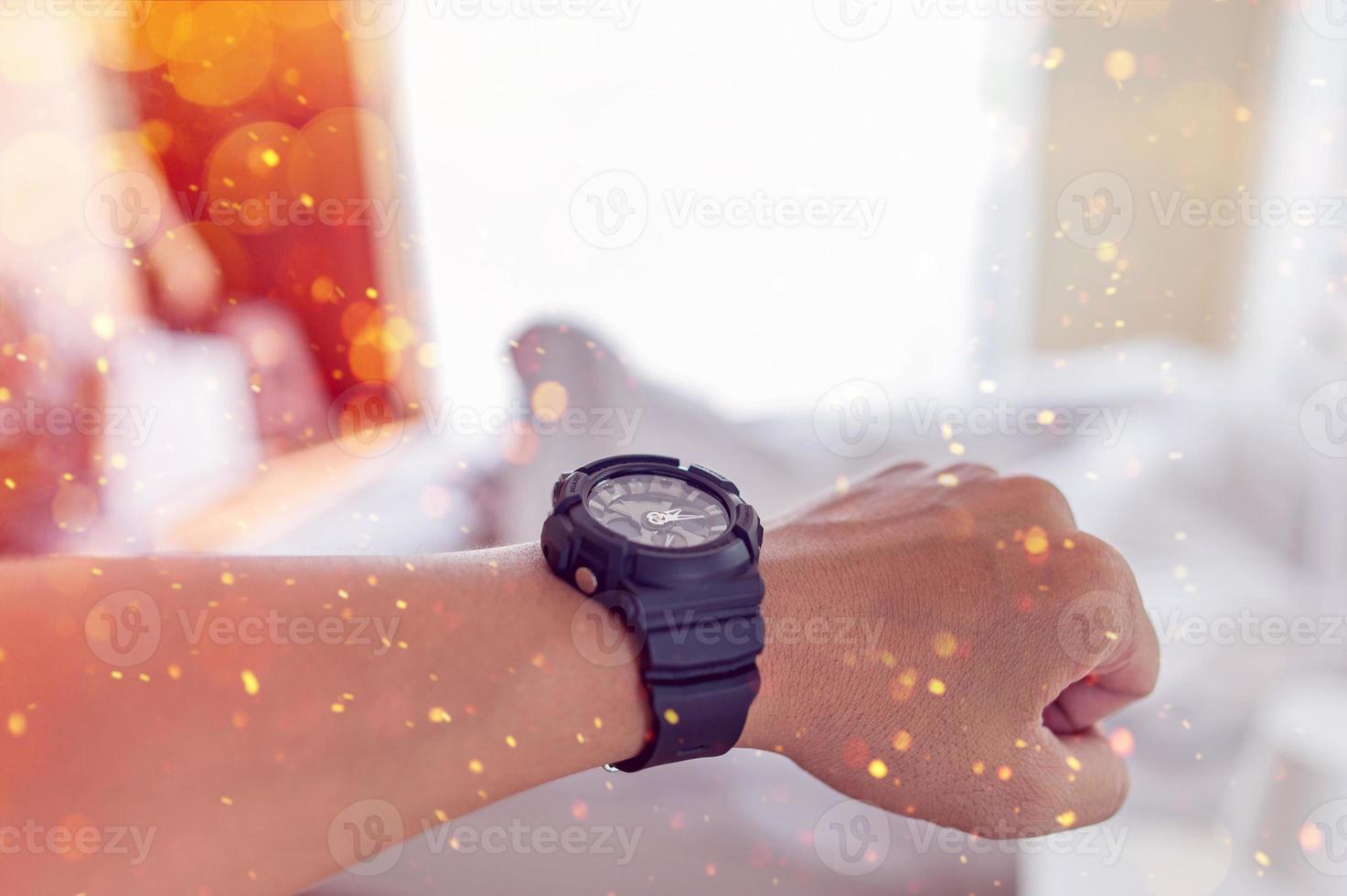 Hands and black watches of young men who like time concept watches photo