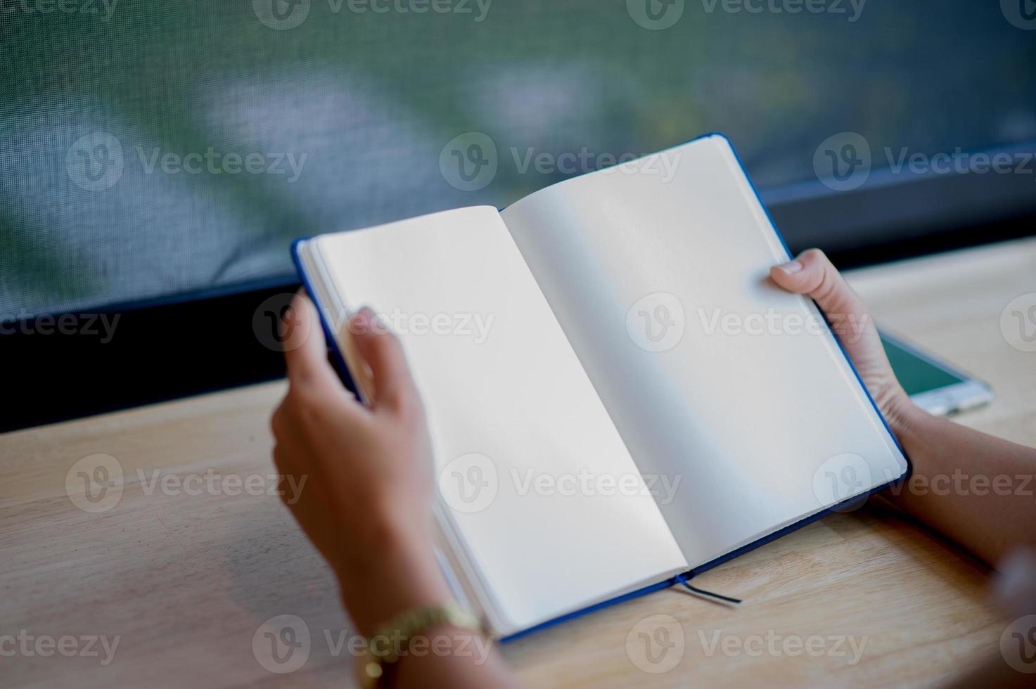 Hands and books that are laid bare with space In the morning room Book reading concept photo