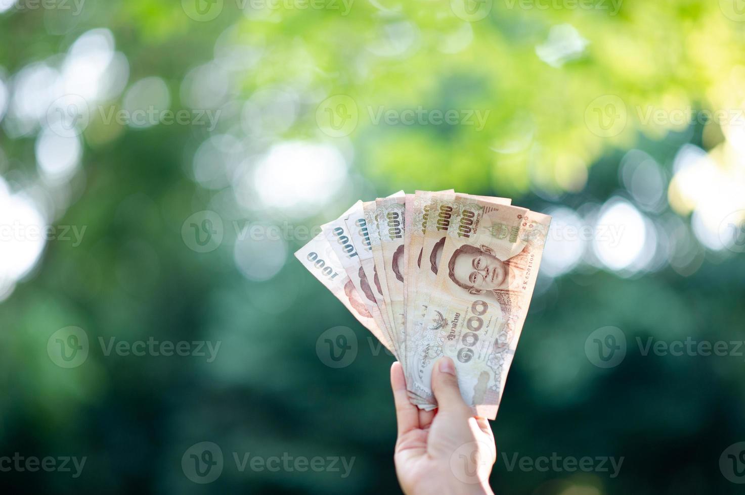 Hand and money, multiple banknotes of financial executives For business and daily spending photo