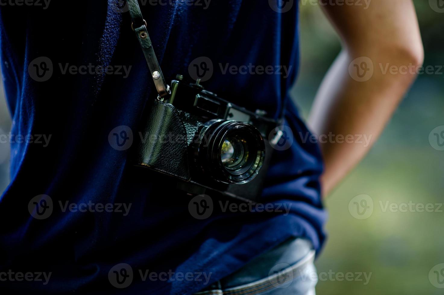 Hand and camera of the photographer Travel in the mountains and nature Concept photographer photo