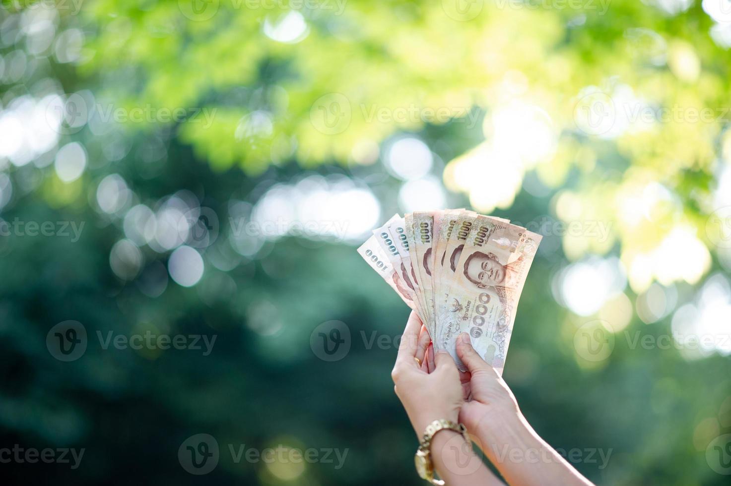 Hand and money, multiple banknotes of financial executives For business and daily spending photo